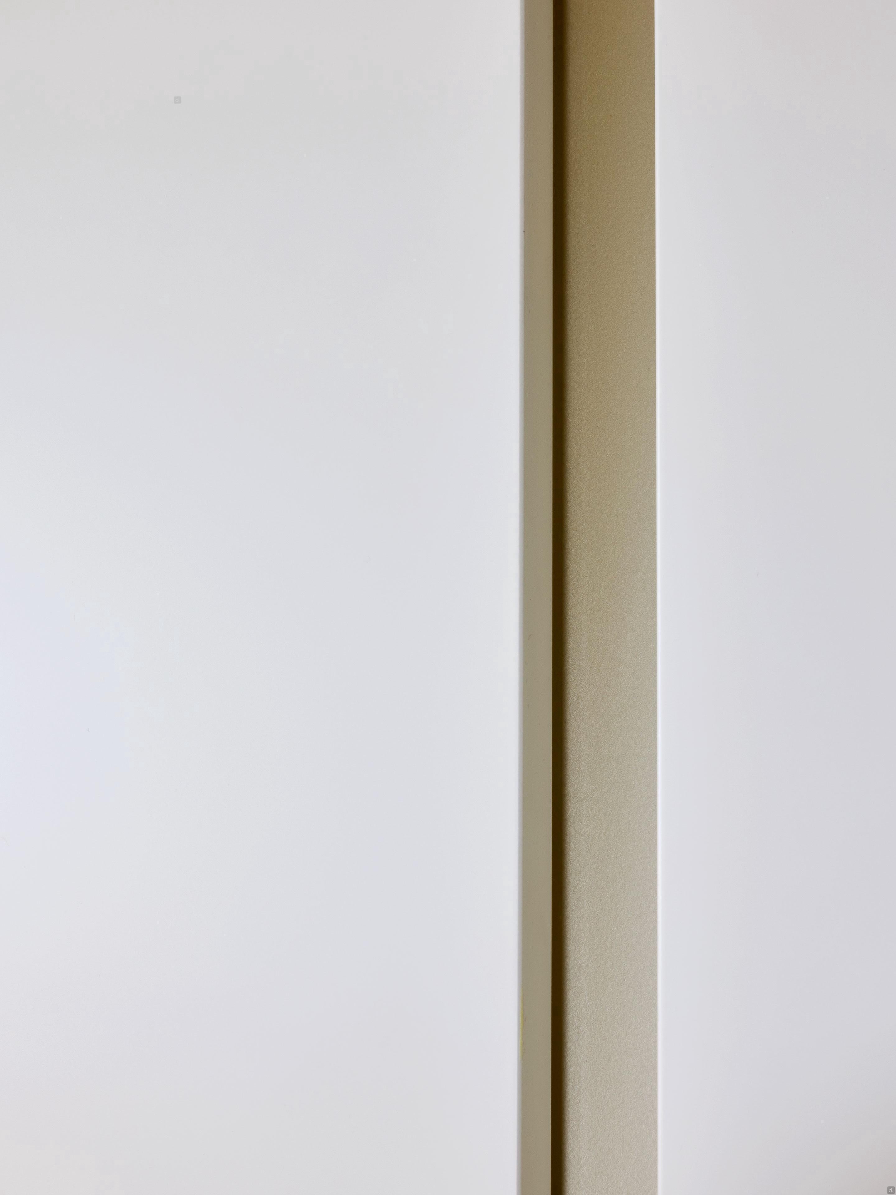 A close-up of a light wall with an off-center beige strip creates a minimal, abstract look—perfect inspiration for Modern Kitchens by Kitchen Furniture, ideal for contemporary Yerevan aesthetics.