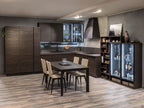 The Urban Kitchens line by ORDER Kitchen Furniture features dark wood cabinets, a custom dining set with four beige chairs, glass-fronted display cabinet, open shelves, light wood flooring, and soft lighting for a cozy atmosphere.