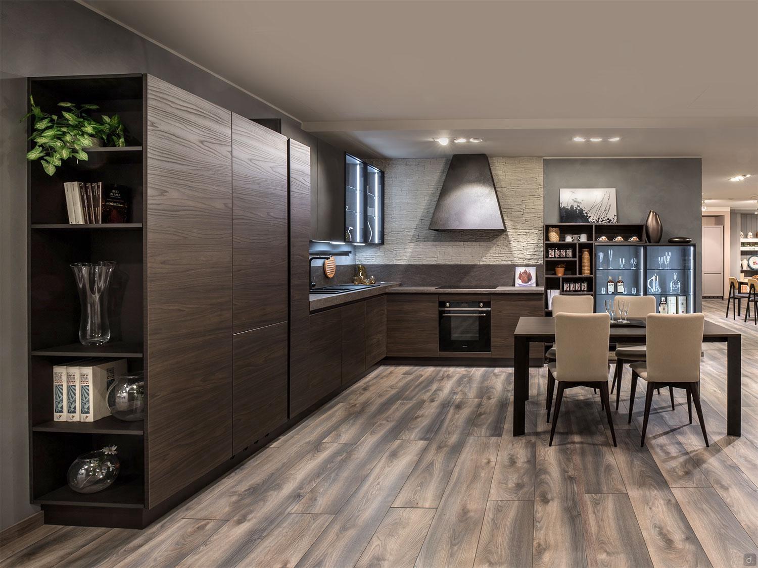 The Urban Kitchens by ORDER Kitchen Furniture features dark wood cabinets, built-in appliances, custom furniture, a dining table with four beige chairs, open shelves, and light wood floors in a contemporary minimalist design.