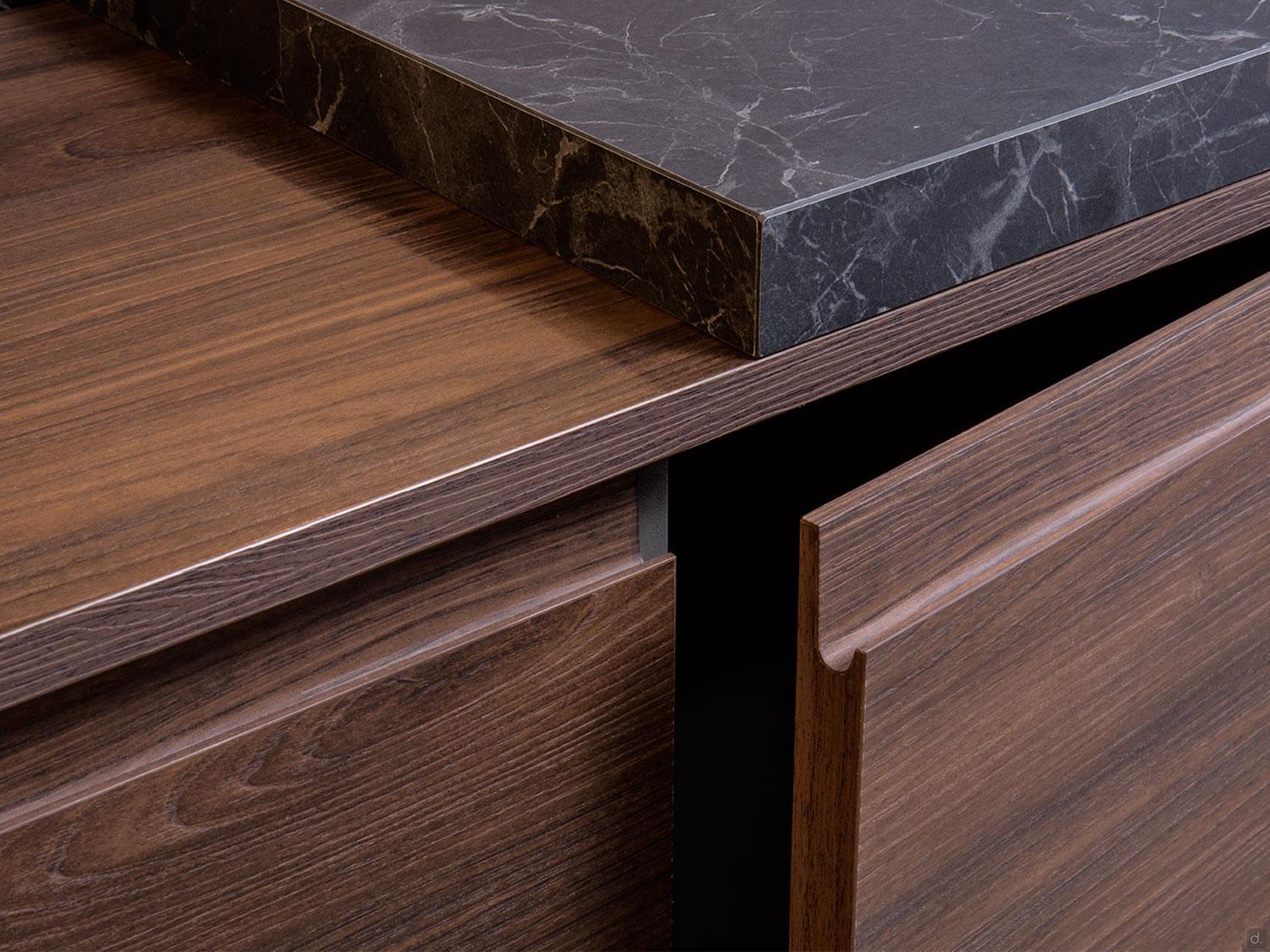 Close-up of Urban Kitchens by ORDER Kitchen Furniture: custom cabinets in dark wood with a black marble countertop, featuring a handle-less, smooth minimalist design—perfect for modern Yerevan homes.