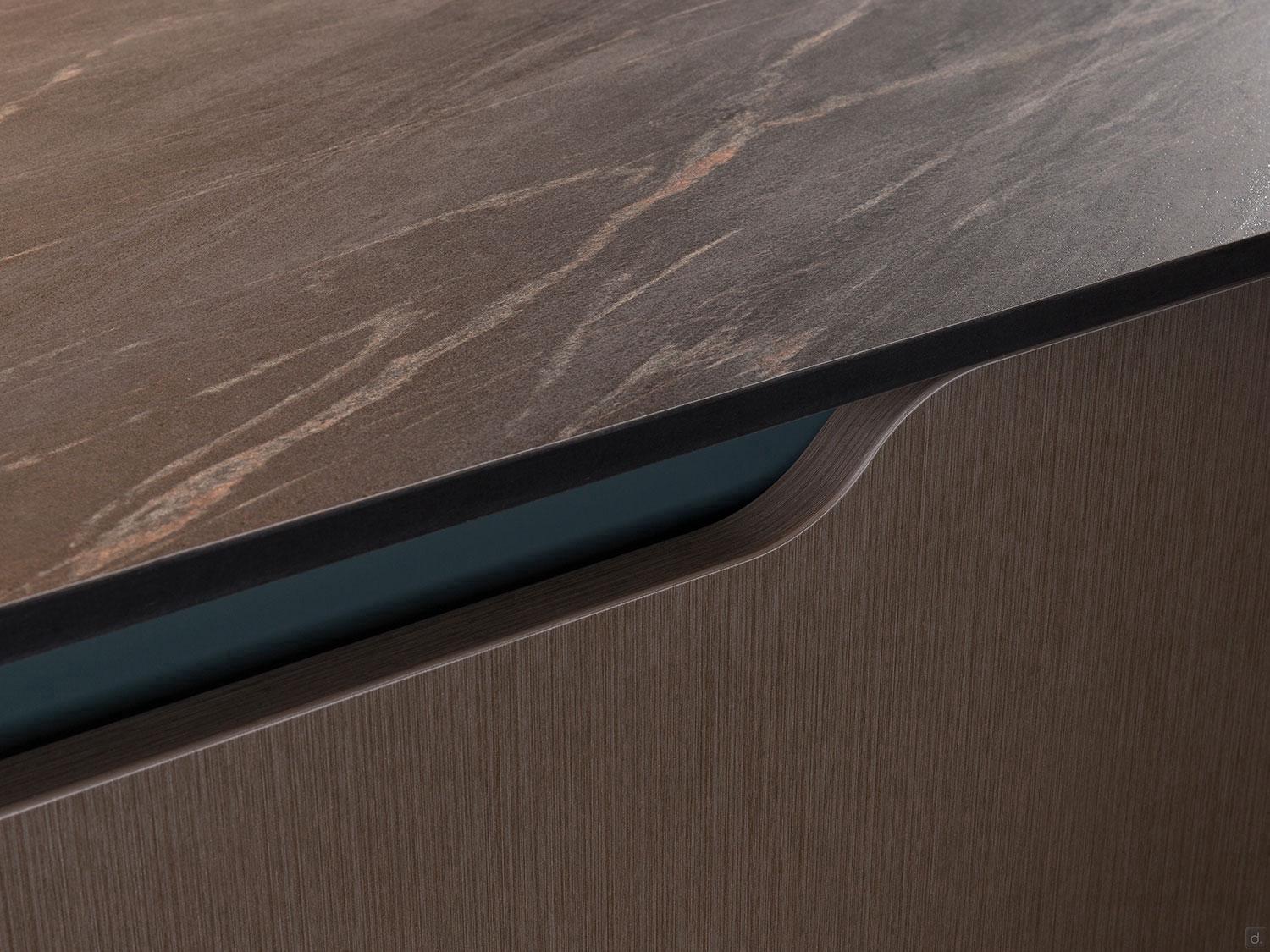 Close-up of ORDER Kitchen Furniture's Urban Kitchens: a matte dark stone countertop with subtle veining and curved edge atop a wood-textured cabinet—ideal for custom urban kitchens in Yerevan.