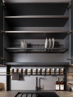 The Urban Kitchens cabinet by ORDER Kitchen Furniture features open doors displaying empty shelves, a dish rack with plates, spice jars, two oil bottles, a sink, and a black faucet—perfect for modern city kitchens in Yerevan.