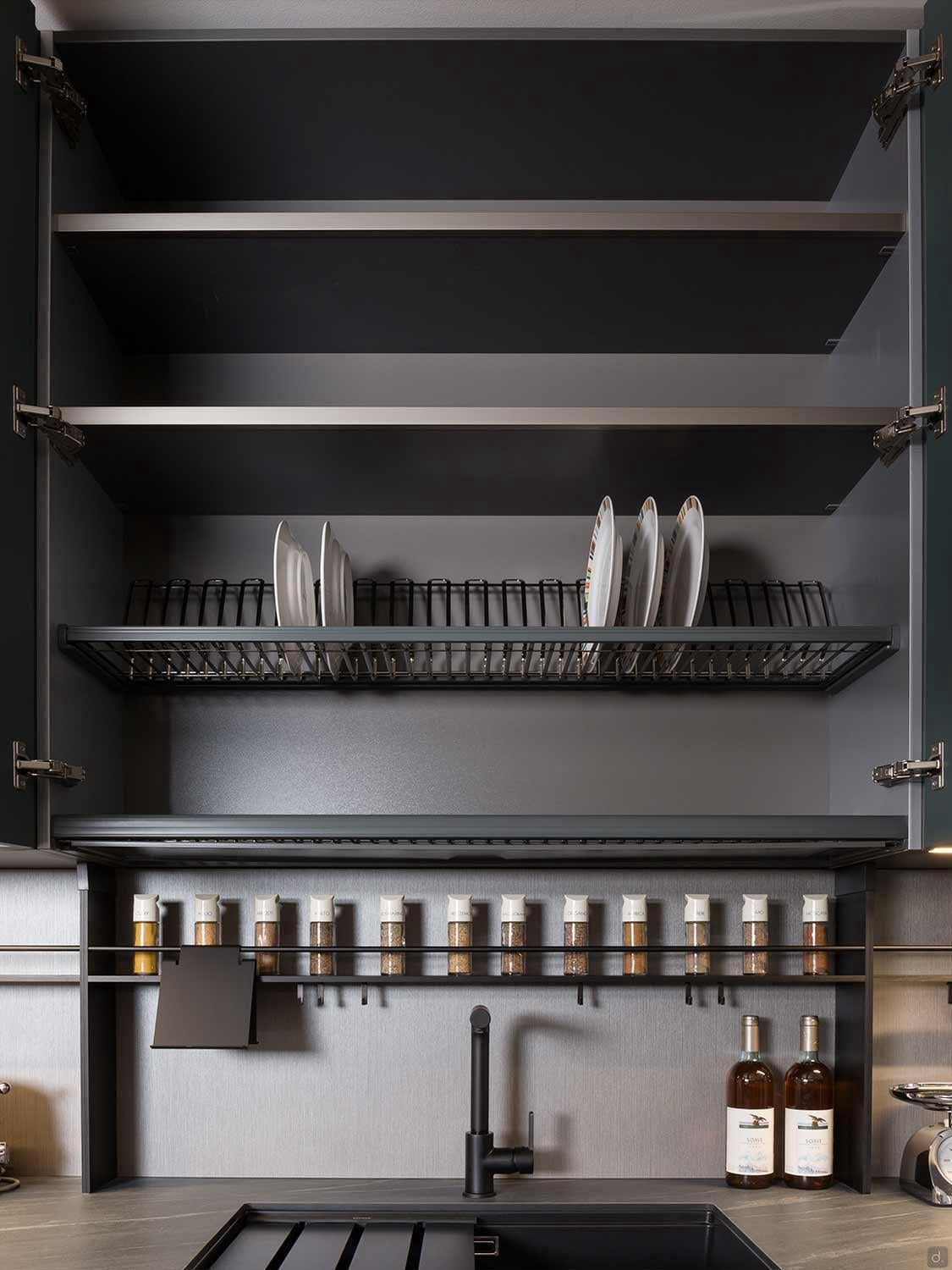 The Urban Kitchens cabinet by ORDER Kitchen Furniture features open doors displaying empty shelves, a dish rack with plates, spice jars, two oil bottles, a sink, and a black faucet—perfect for modern city kitchens in Yerevan.