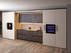 Urban Kitchens by Kitchen Furniture features sleek cabinets, built-in oven, wine fridge, minimalist countertop, under-cabinet lighting, and wood flooring. Neutral tones and clean lines deliver a contemporary, organized look for urban spaces.