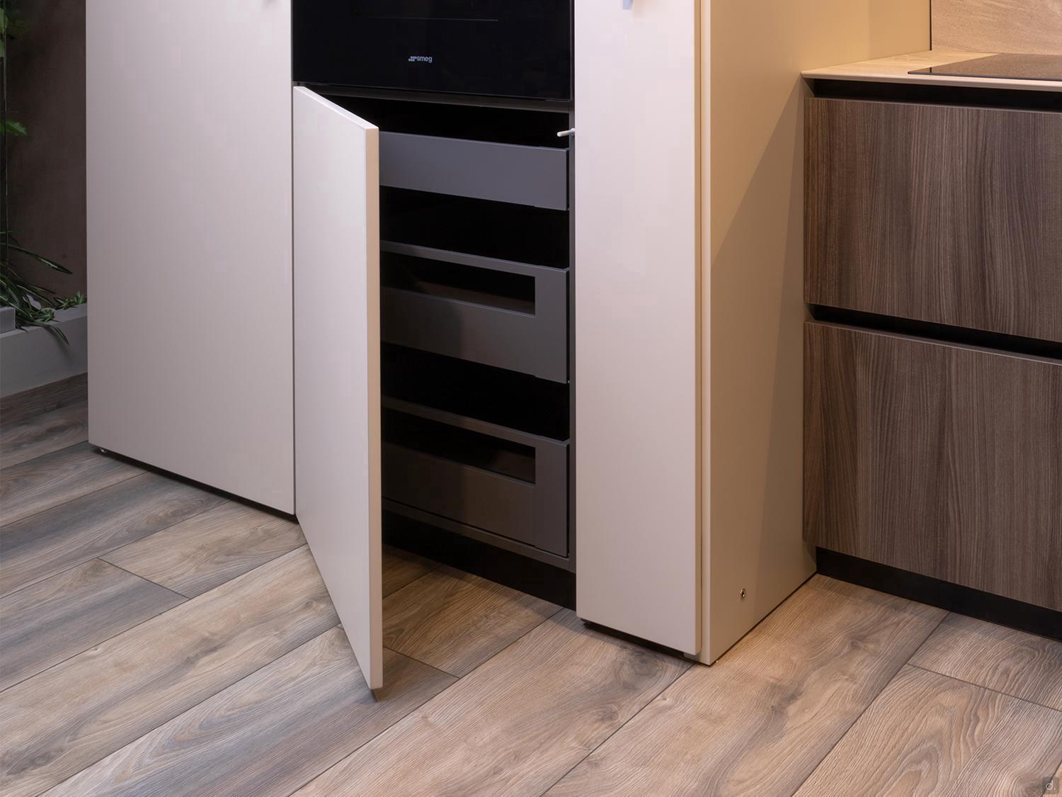 Urban Kitchens by Kitchen Furniture features a modern Yerevan design with light wood floors, a beige cabinet door open to reveal sleek black drawers, and a dark wood cabinet for a chic urban look.